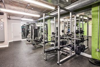 A gym with weights and other equipment in a building